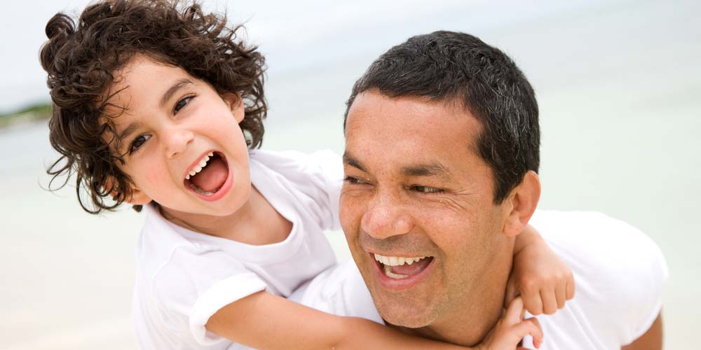 Father Son of Family laughing on back